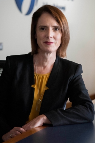 Close up shot of Dr Helen Neil, General Manager - Operations, smiling in business casual.