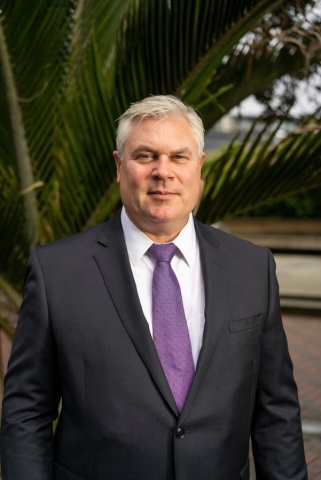 Close-up shot of Warrick Johnston, General Manager - Technology & Innovation, in a suit and tie.
