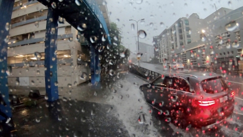 Car driving through heavy rain on a highway