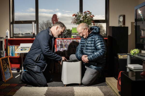 Project leader Dr Ian Longley demonstrates a portable air cleaner to an Air Action volunteer.